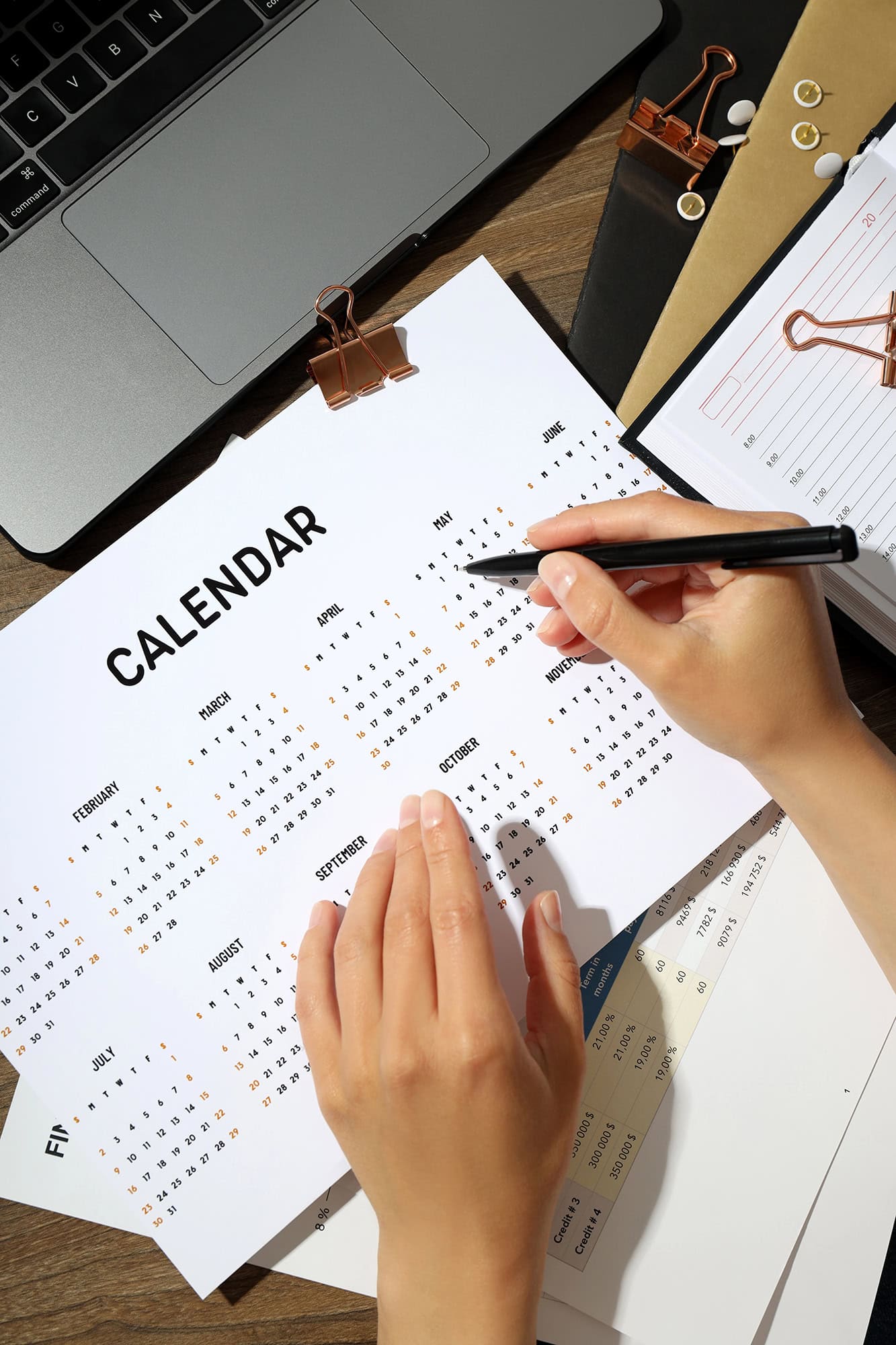 Event planner in Corona, CA coordinating timelines on a planning calendar by Chef Bill Blackburn